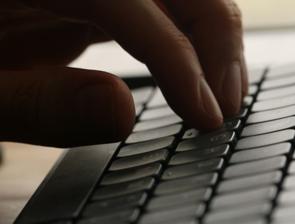 Mãos digitando no teclado durante análise de banco de dados